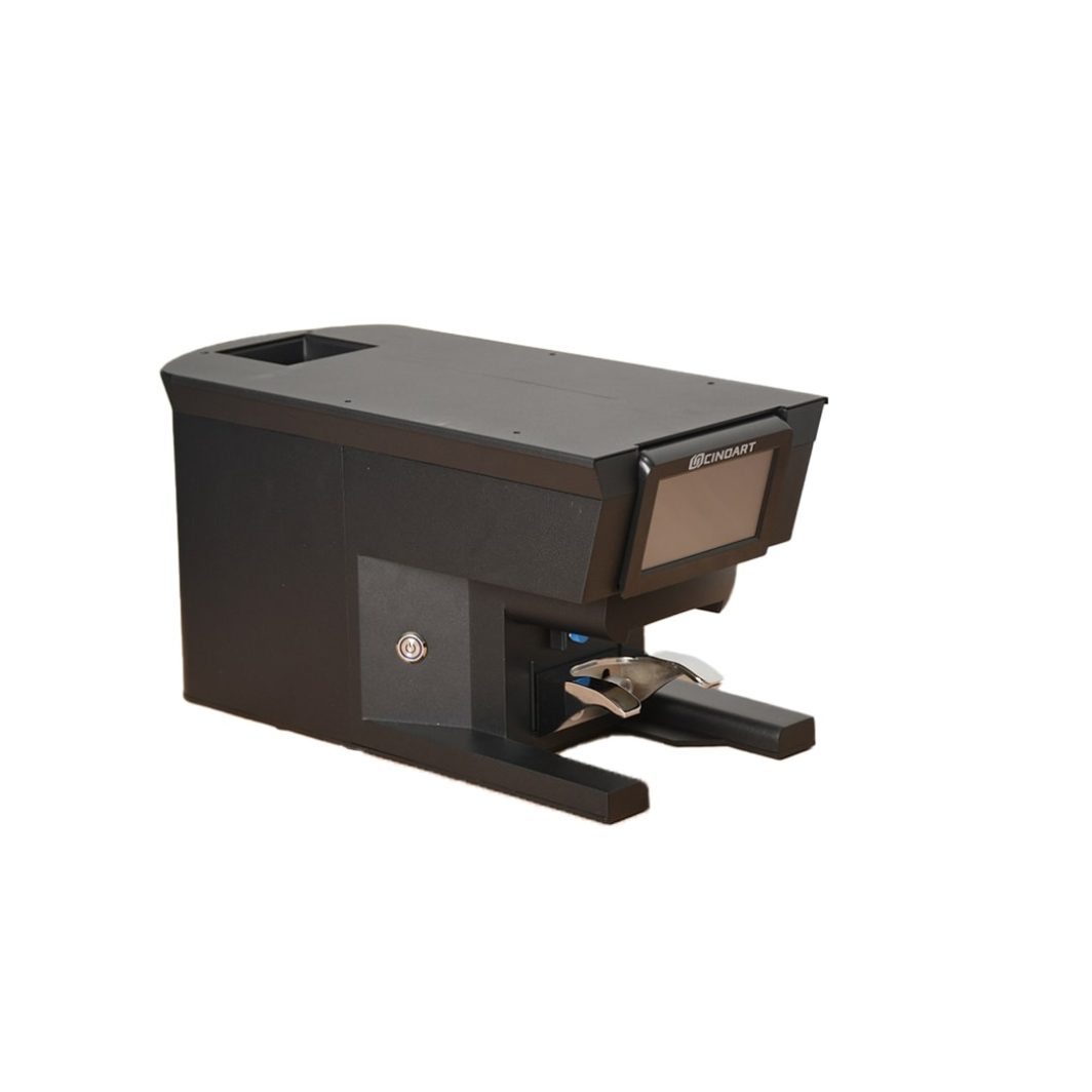 CinoArt PTB automatic coffee tamper mounted below a commercial grinder