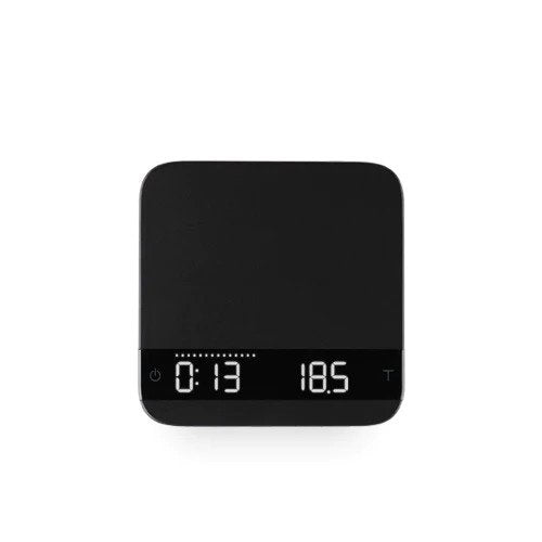 Acaia Lunar espresso scale placed on an espresso machine drip tray